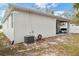 Rear exterior of a home with a covered patio area and green space at 4104 E Comanche Ave, Tampa, FL 33610