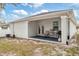 Spacious backyard with a covered patio, seating, and barbecue grill, perfect for outdoor entertainment at 4104 E Comanche Ave, Tampa, FL 33610