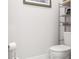 Modern bathroom with white toilet, shelving unit, and neutral color scheme at 4104 E Comanche Ave, Tampa, FL 33610