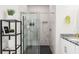 Modern bathroom featuring a glass-enclosed shower with marble tiling and a sleek vanity at 4104 E Comanche Ave, Tampa, FL 33610