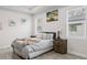 Well-lit bedroom with decorative artwork, a comfortable bed, and windows at 4104 E Comanche Ave, Tampa, FL 33610