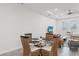 Dining area with a round table, wicker chairs, and a view into the adjacent living room at 4104 E Comanche Ave, Tampa, FL 33610