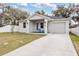 Beautiful home with a well-kept lawn, inviting porch, and a convenient attached garage at 4104 E Comanche Ave, Tampa, FL 33610
