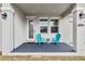 Inviting front porch features stylish columns, outdoor lighting, and comfortable seating at 4104 E Comanche Ave, Tampa, FL 33610