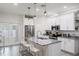 Bright kitchen featuring white cabinets, stainless steel appliances, and a granite countertop island at 4104 E Comanche Ave, Tampa, FL 33610