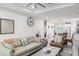 Open-concept living room with stylish furniture, an inviting atmosphere, and a view of the modern kitchen at 4104 E Comanche Ave, Tampa, FL 33610
