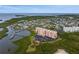 Waterfront condo building, marina and stunning coastal community from an aerial perspective at 4516 Seagull Dr # 614, New Port Richey, FL 34652