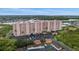 Aerial view of the condo building with lush greenery and waterfront nearby at 4516 Seagull Dr # 614, New Port Richey, FL 34652