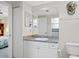 Well-lit bathroom featuring modern vanity with a granite countertop and decorative mirror at 4516 Seagull Dr # 614, New Port Richey, FL 34652
