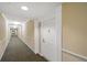 Hallway with neutral wall color, and clean design, leading to resident room at 4516 Seagull Dr # 614, New Port Richey, FL 34652