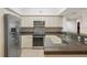 Kitchen featuring stainless steel appliances, white cabinetry, and stone countertops at 4516 Seagull Dr # 614, New Port Richey, FL 34652