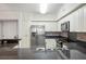 Kitchen showcasing stainless steel appliances, modern white cabinets, and stone countertops at 4516 Seagull Dr # 614, New Port Richey, FL 34652