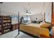 Spacious main bedroom features a four-poster bed, ceiling fan and a view at 4516 Seagull Dr # 614, New Port Richey, FL 34652