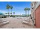 Resort-style pool surrounded by lounge chairs and palm trees at 4516 Seagull Dr # 614, New Port Richey, FL 34652
