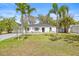 The home's exterior has curb appeal from the lawn and surrounding palm trees at 4625 W Bay Villa Ave, Tampa, FL 33611