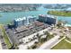 Elevated view showcases a condominium building with waterfront and manicured landscapes at 500 Treasure Island Cswy # 402, Treasure Island, FL 33706