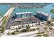Panoramic aerial view of a condominium building near water and a bridge at 500 Treasure Island Cswy # 402, Treasure Island, FL 33706
