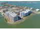 Aerial view of condominium buildings situated near waterfront and recreational areas at 500 Treasure Island Cswy # 402, Treasure Island, FL 33706