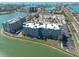 Elevated view showcases condominium building with parking and scenic waterfront location at 500 Treasure Island Cswy # 402, Treasure Island, FL 33706