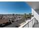 Balcony overlooks a full parking lot with palm trees, buildings, and sunny blue skies at 500 Treasure Island Cswy # 402, Treasure Island, FL 33706