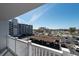 Balcony shot overlooking covered parking and distant buildings and sunny blue skies at 500 Treasure Island Cswy # 402, Treasure Island, FL 33706