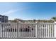 Balcony view shows the parking lot and distant view of buildings and palm trees on a sunny day at 500 Treasure Island Cswy # 402, Treasure Island, FL 33706