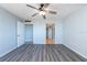 Large bedroom with wood-look flooring, ceiling fan and dual closets at 500 Treasure Island Cswy # 402, Treasure Island, FL 33706