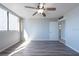 Spacious bedroom with wood-look floors, ceiling fan and natural light at 500 Treasure Island Cswy # 402, Treasure Island, FL 33706
