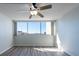 Bright bedroom with wood-look floors and expansive windows providing natural light and views at 500 Treasure Island Cswy # 402, Treasure Island, FL 33706
