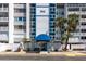 The condo's entrance features a blue awning and well-kept landscaping at 500 Treasure Island Cswy # 402, Treasure Island, FL 33706