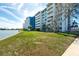 Grassy lawn bordering tranquil waters at 500 Treasure Island Cswy # 402, Treasure Island, FL 33706