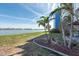 Lush green lawn extends to the tranquil waters beyond, lined with palm trees at 500 Treasure Island Cswy # 402, Treasure Island, FL 33706