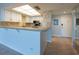 Bright kitchen featuring white cabinetry and modern appliances, and breakfast bar at 500 Treasure Island Cswy # 402, Treasure Island, FL 33706