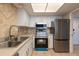 Clean kitchen with tiled flooring, stainless steel appliances, and ample counter space at 500 Treasure Island Cswy # 402, Treasure Island, FL 33706