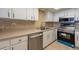 Modern kitchen with stainless steel appliances, neutral countertops, and white cabinets at 500 Treasure Island Cswy # 402, Treasure Island, FL 33706