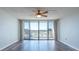 Open living space with sliding glass doors to balcony and wood flooring at 500 Treasure Island Cswy # 402, Treasure Island, FL 33706