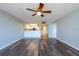 Open-concept living area with wood-look floors leading to a well-lit kitchen at 500 Treasure Island Cswy # 402, Treasure Island, FL 33706