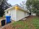 Exterior shot of a house with light siding, a compact yard, and basic backyard with green space at 5439 County Road 579, Seffner, FL 33584