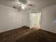 Neutral bedroom with a ceiling fan, closet and doorway, featuring a mix of carpeted flooring at 5439 County Road 579, Seffner, FL 33584