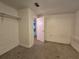 A simple, minimalist bedroom with neutral walls, carpet, and a small closet with shelving at 5439 County Road 579, Seffner, FL 33584