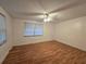 Bright bedroom with hardwood floors, a ceiling fan, and natural light streaming through the window at 5439 County Road 579, Seffner, FL 33584