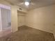 A simple bedroom with a ceiling fan, closet, and an adjacent room, all featuring neutral colors at 5439 County Road 579, Seffner, FL 33584