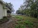 Features the front of a house with a basic lawn and minimal landscaping, near a paved road at 5439 County Road 579, Seffner, FL 33584