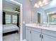 Bathroom with gray vanity, granite countertop, and bedroom entrance view at 5703 Colony Glen Rd, Lithia, FL 33547