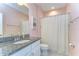 Pink bathroom featuring a patterned shower curtain and granite countertop vanity at 5703 Colony Glen Rd, Lithia, FL 33547