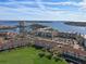 Gorgeous aerial view of waterfront condos, manicured lawns, and a scenic bridge in the background at 6021 Bahia Del Mar Cir # 234, St Petersburg, FL 33715