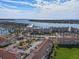Expansive aerial view featuring a residential community near the water, palm trees, and parking areas at 6021 Bahia Del Mar Cir # 234, St Petersburg, FL 33715