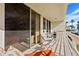 Cozy balcony features comfortable seating and scenic views through large sliding glass doors at 6021 Bahia Del Mar Cir # 234, St Petersburg, FL 33715