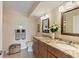 Bright bathroom with double vanity sinks, granite countertops, decorative mirrors and tile flooring at 6021 Bahia Del Mar Cir # 234, St Petersburg, FL 33715