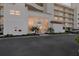 Condominium exterior with a modern facade, visible unit number, well-maintained landscaping, and ample parking at 6021 Bahia Del Mar Cir # 234, St Petersburg, FL 33715